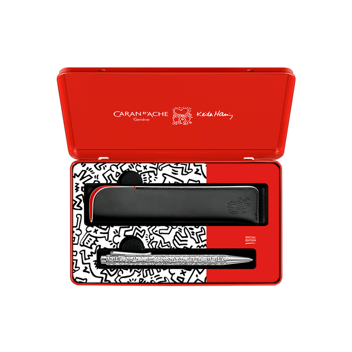 This Ecridor Keith Haring Ballpoint Pen Set, Special Edition  by Caran d'Ache is made from brass and platinum and has a leather case. 